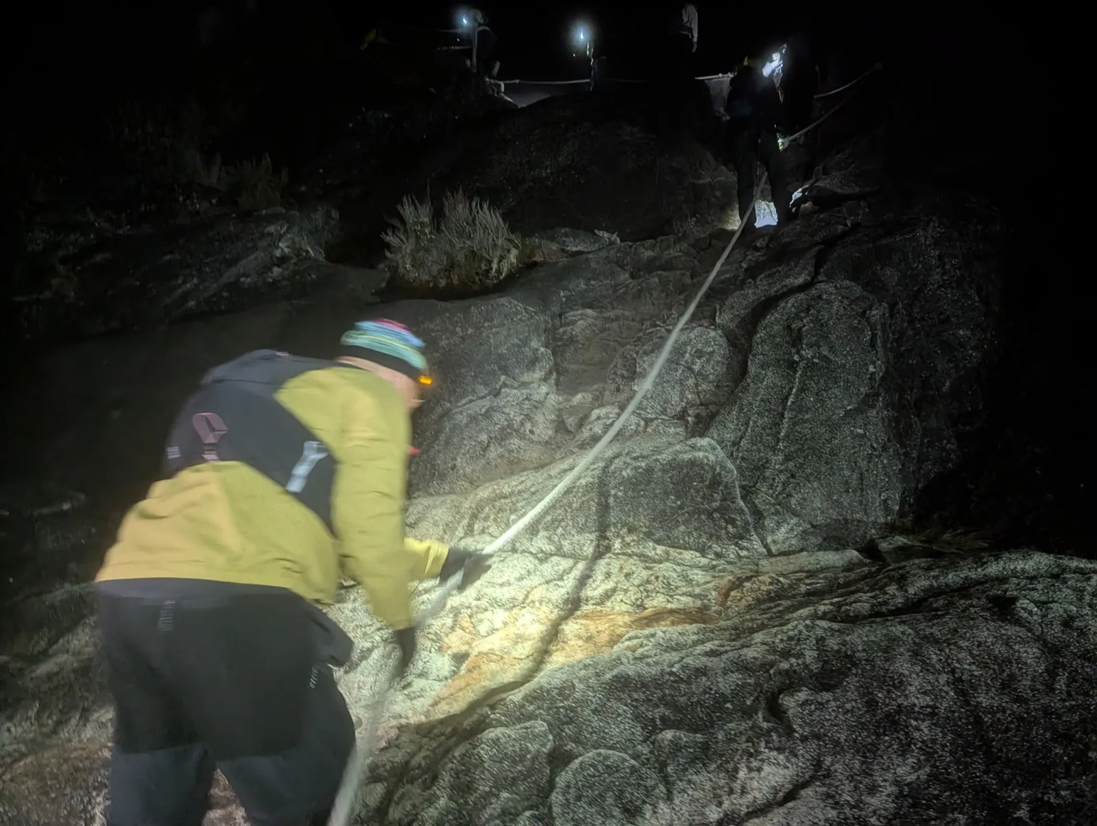 Climbing the granite slab with the fixed rope